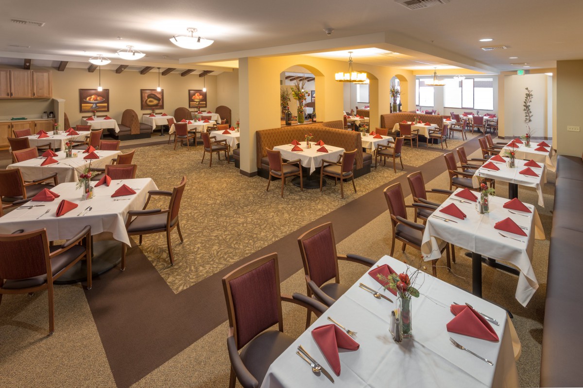 An inviting dining area with neatly arranged tables and chairs, set for service.