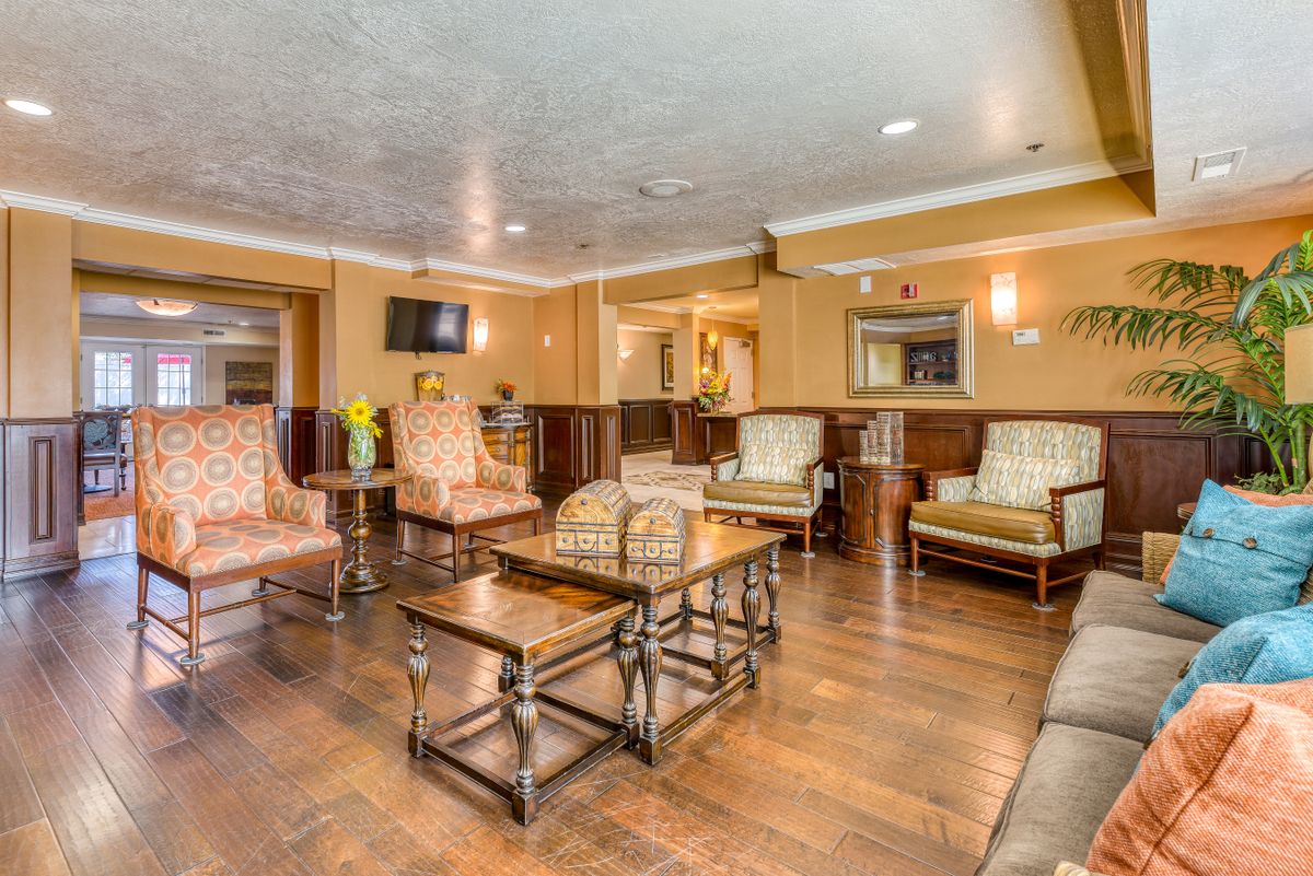 A cozy waiting room with comfortable seating and wooden furnishings.