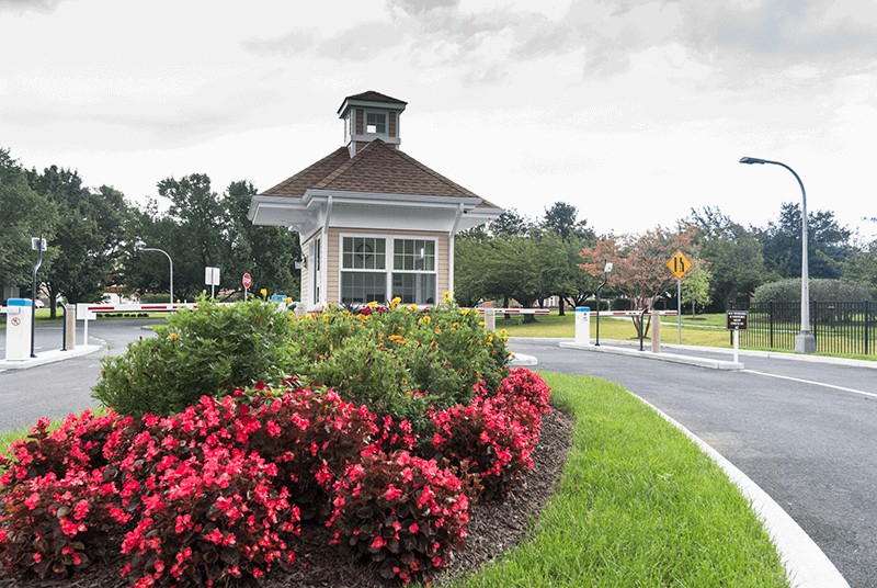 A scenic view featuring a landscaped garden with vibrant flowers and a small gazebo structure.