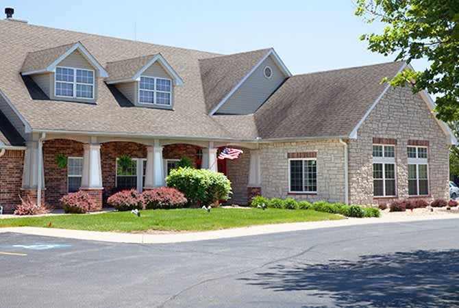 A suburban house with a well-maintained lawn and driveway.