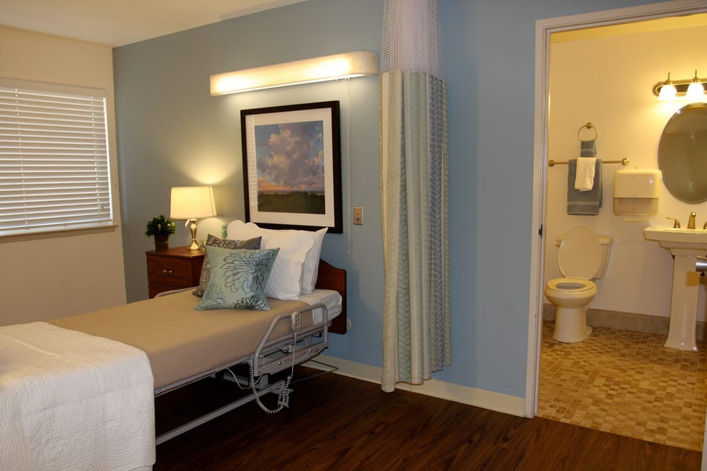 A well-furnished hospital room with a comfortable medical bed and calming decor.