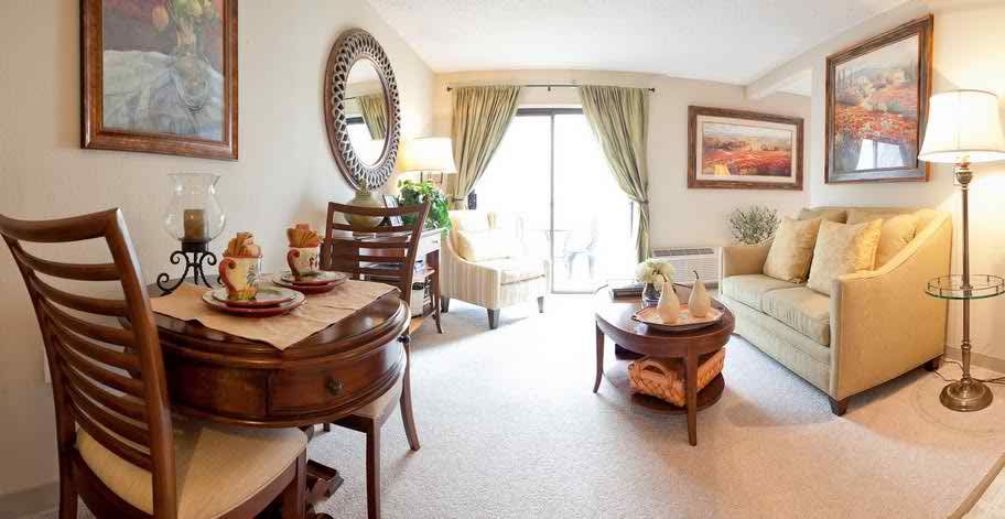 A cozy living room with a dining area, featuring elegant furniture and decor.