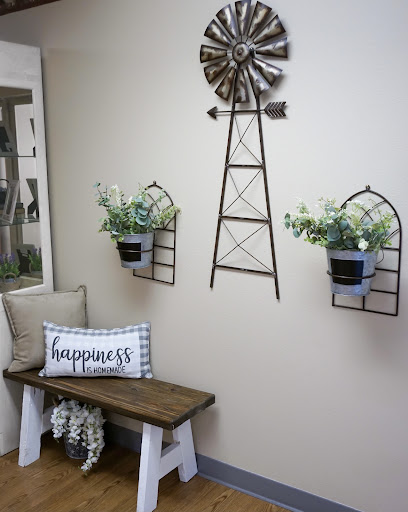 A charming country-style home decor setup featuring a decorative windmill and stylish plant holders.