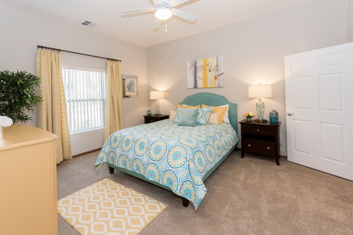 A cozy bedroom with a stylish bed, bedside tables, and decorative elements.
