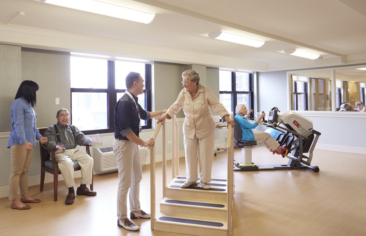 Seniors participating in rehabilitation exercises at a physical therapy center.