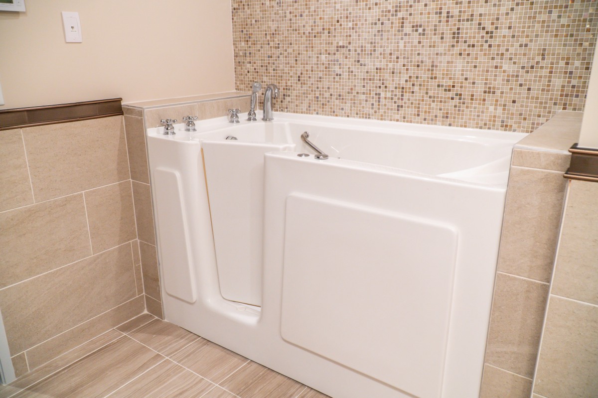 A modern walk-in bathtub in a stylish bathroom setting.