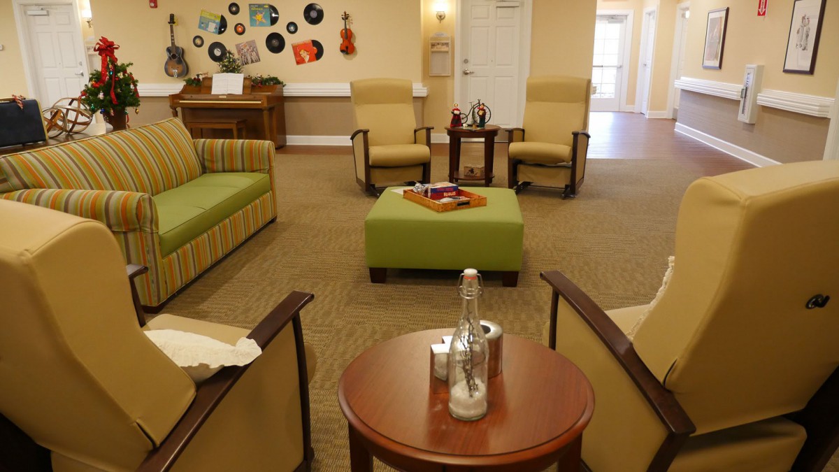 A cozy living room with comfortable seating and decorative elements.
