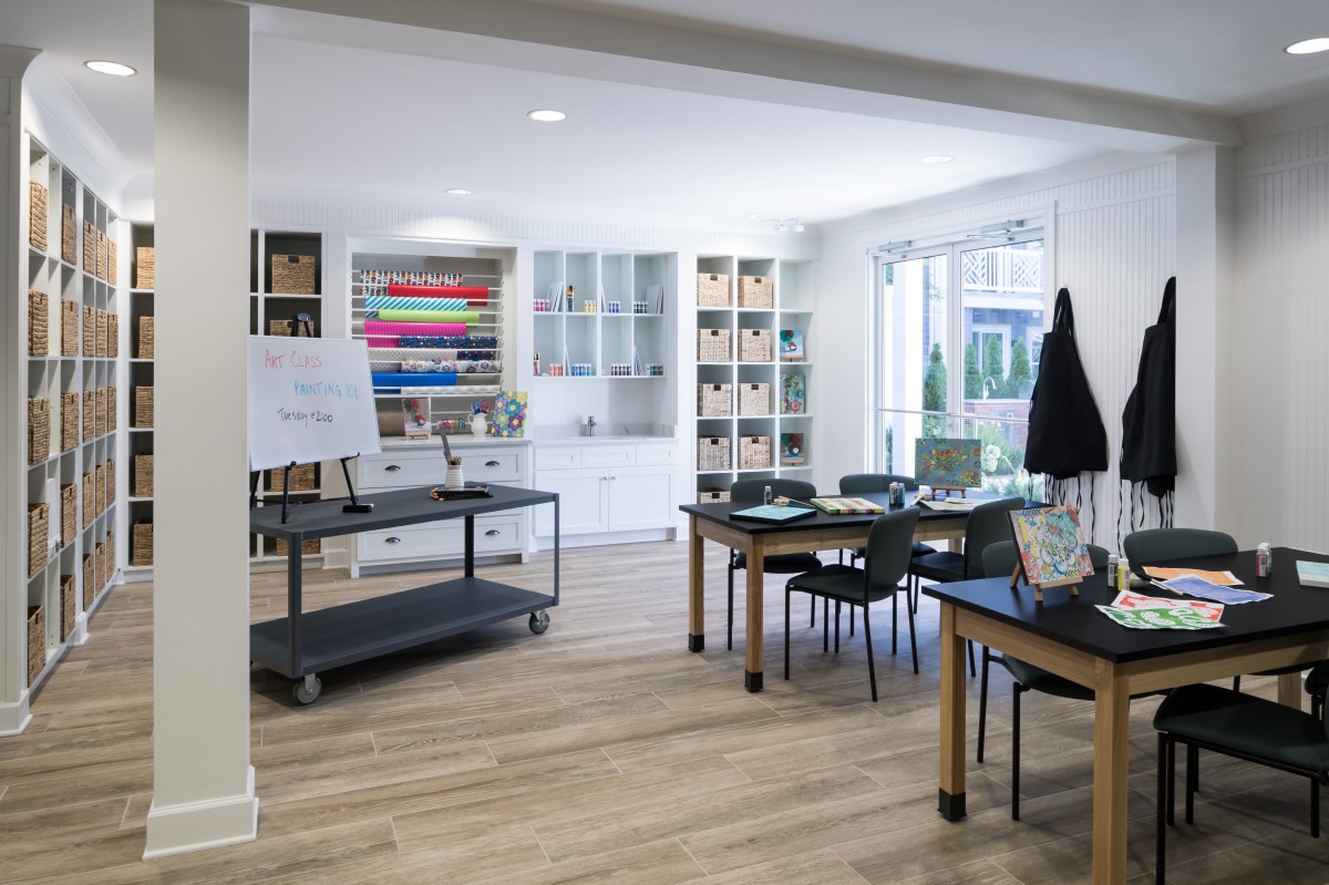 A well-organized classroom or workshop space with art supplies, tables, and chairs.