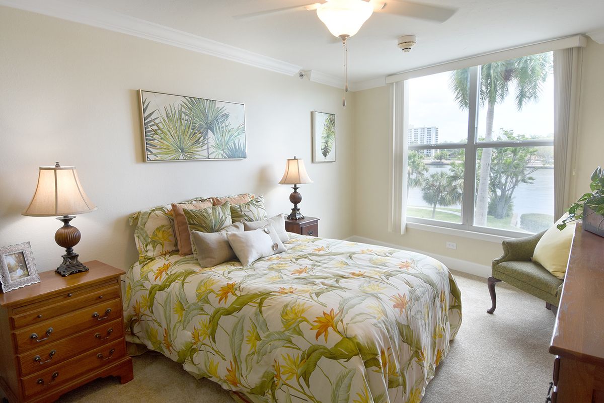 A cozy bedroom with floral bedding and natural light.