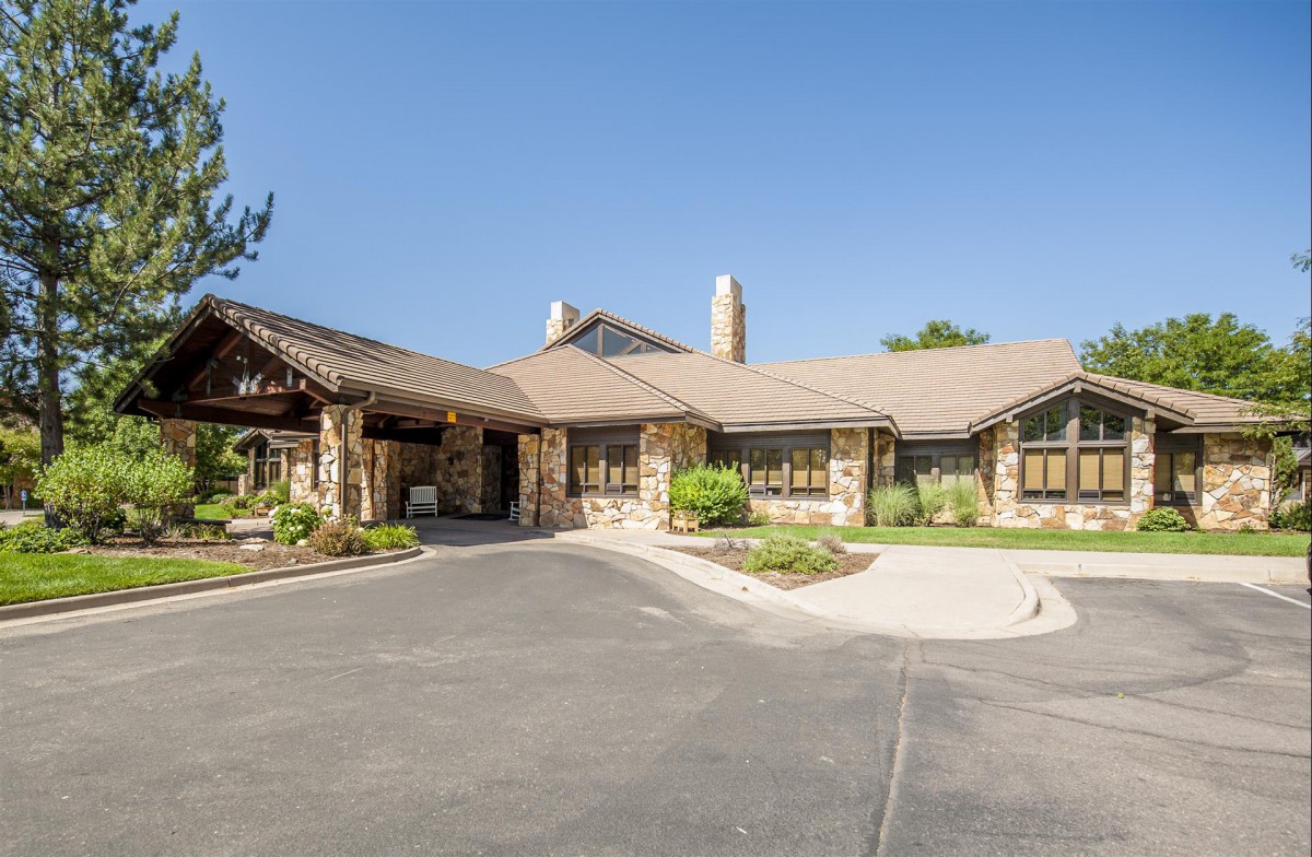A traditional style house with a stone exterior and well-maintained landscaping.
