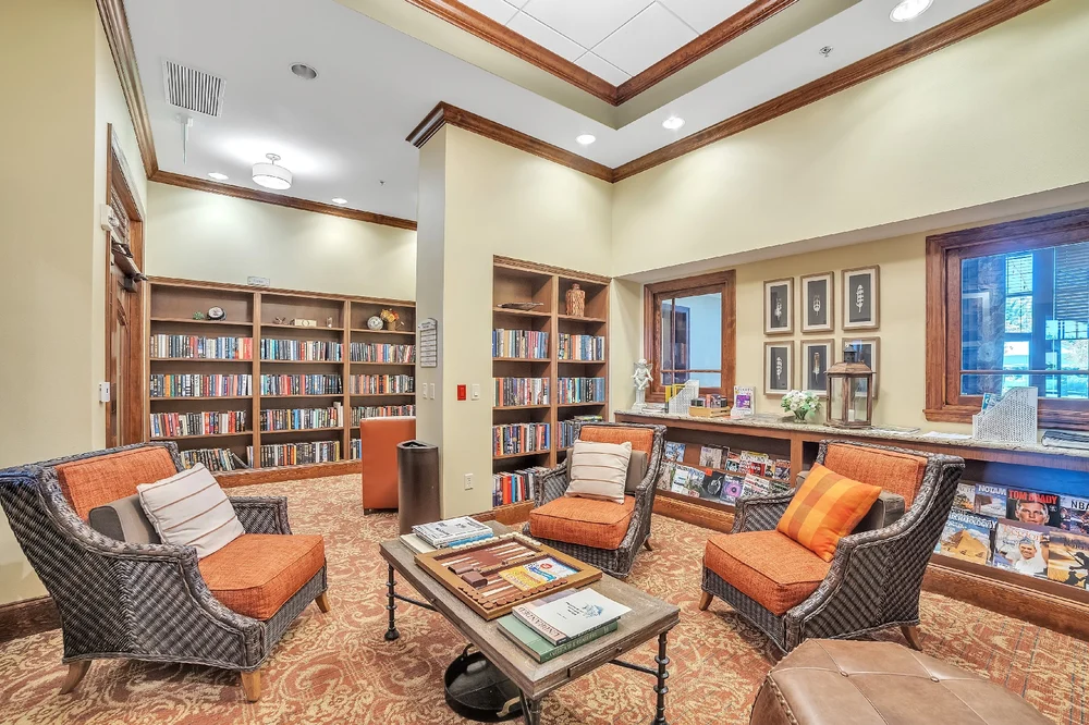 A cozy library interior with bookshelves and a comfortable reading area.