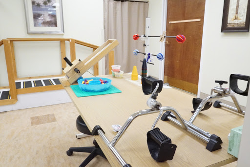 A physical therapy room equipped with various rehabilitation tools and exercise equipment.