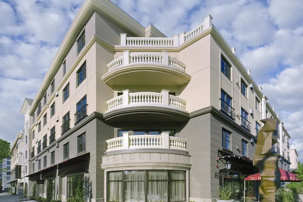 A modern urban building with distinctive balconies and a neutral facade.