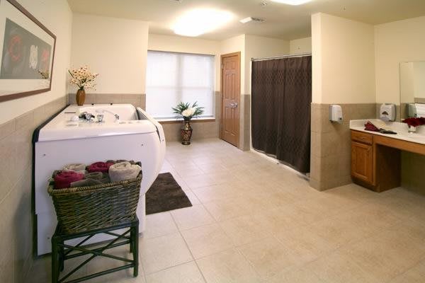 A spacious and modern bathroom featuring a bathtub and shower.