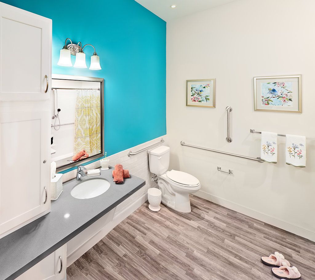 A modern bathroom with a vibrant blue accent wall and contemporary fixtures.