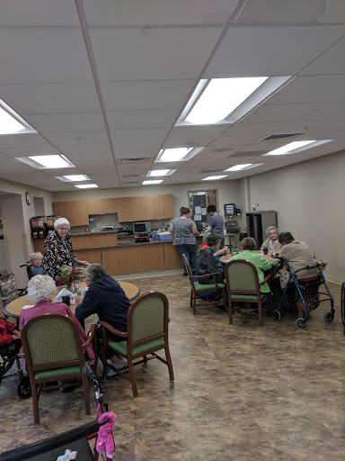 A warm and inviting dining area where seniors gather for a meal and social interaction.