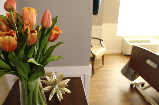 A cozy interior featuring a vase of vibrant tulips, adding a touch of nature to the stylishly decorated room.