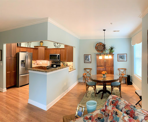 A cozy open-concept living space featuring a kitchen and dining area with stylish wooden furniture and a relaxing atmosphere.