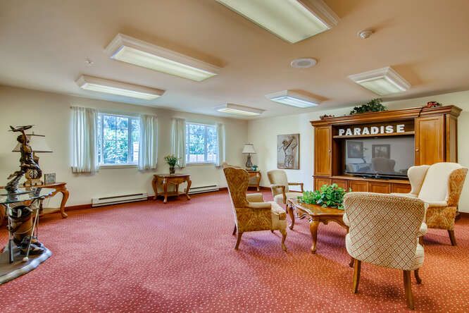 A spacious office room with comfortable seating and large windows.