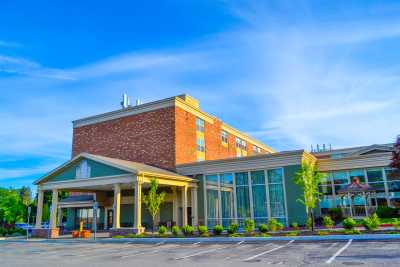 A well-maintained hotel building with a clear blue sky in the background.