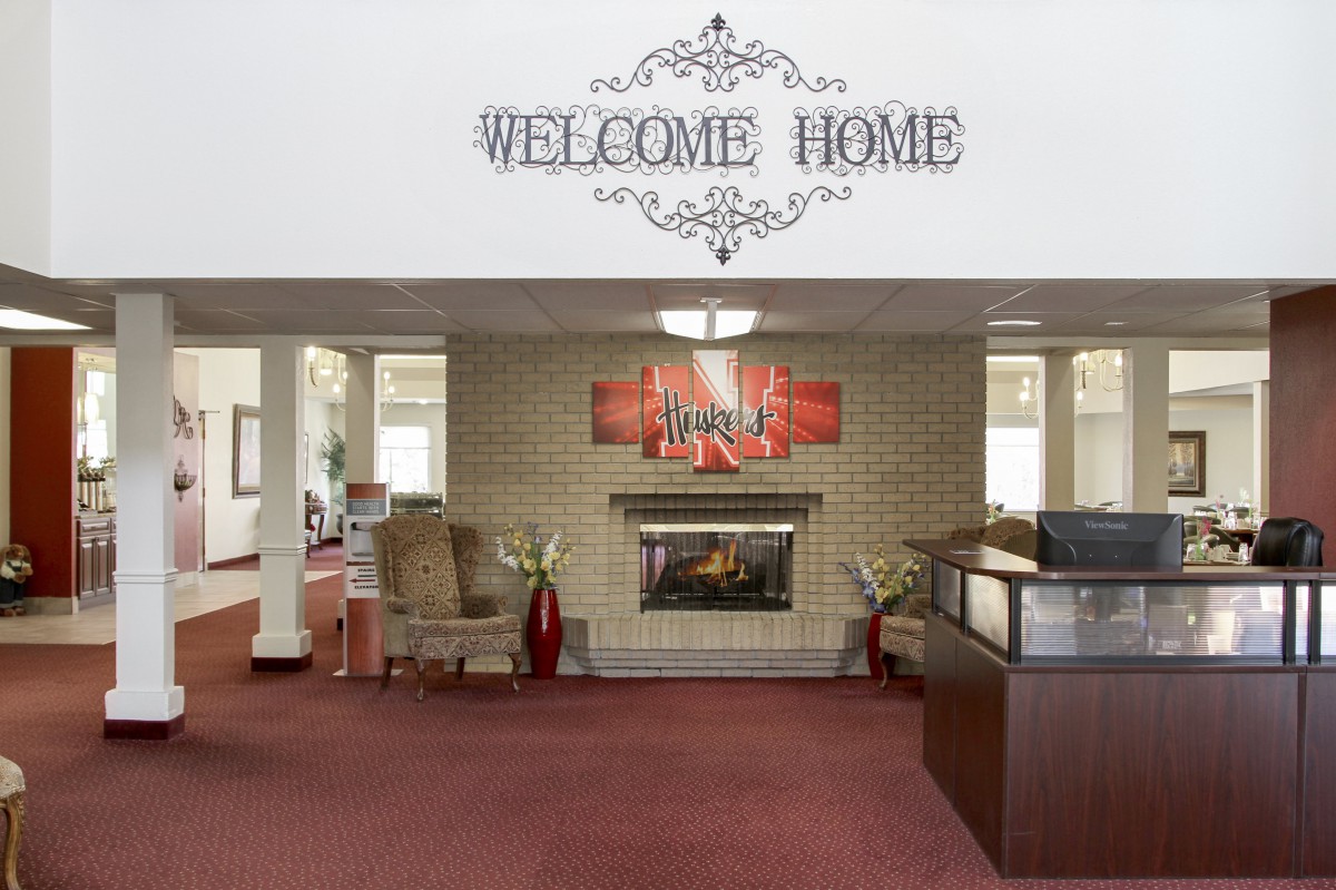 A welcoming lobby with a fireplace, comfortable seating, and decorative elements.
