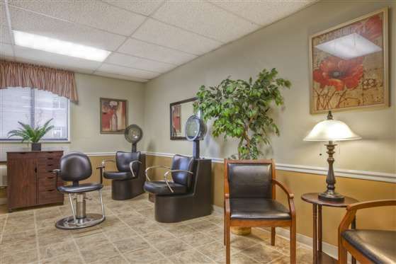 A cozy salon waiting area with seating and hair dryers.