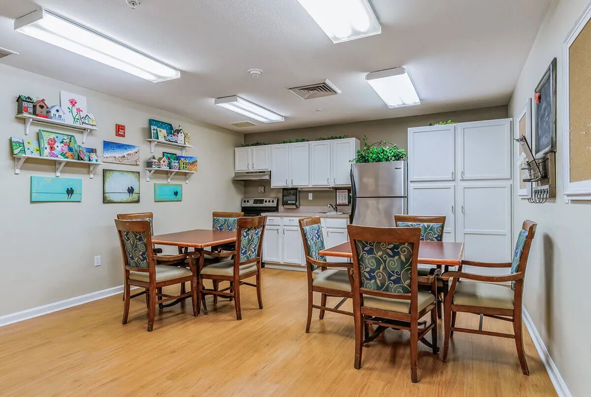 A cozy kitchen and dining area with wooden tables and chairs, featuring modern appliances and stylish decor.