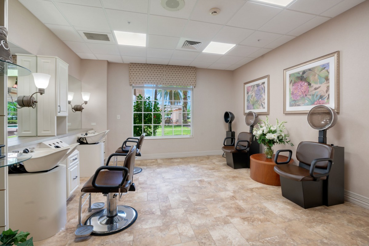A bright and modern beauty salon interior with styling chairs and a well-organized waiting area.
