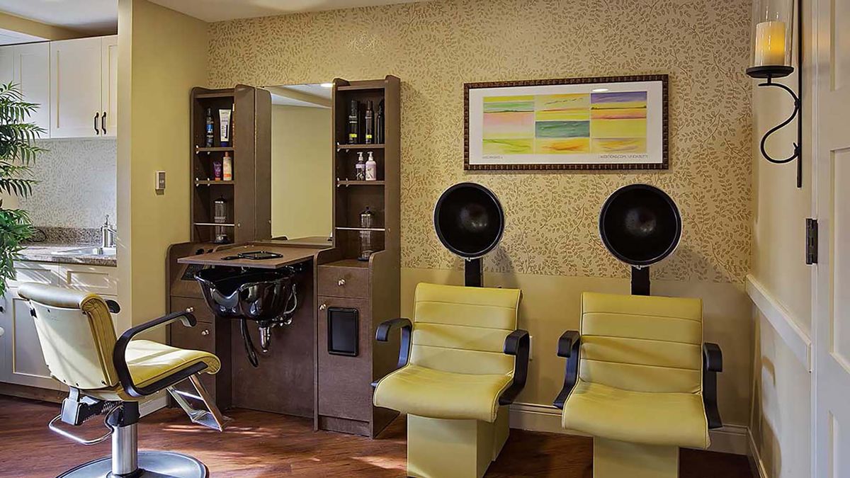 A cozy hair salon with comfortable seating and modern styling equipment.