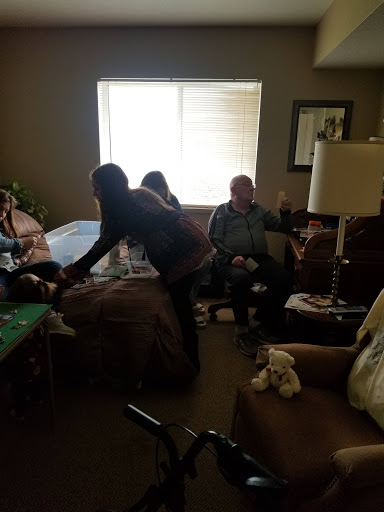 A casual indoor gathering with friends or family, enjoying each other's company.