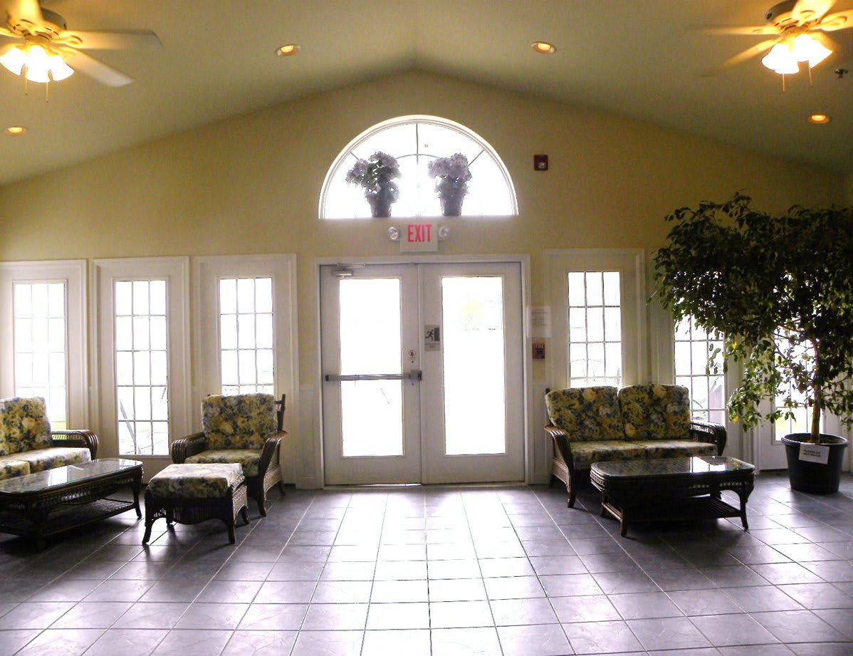 A well-lit lobby or waiting area with comfortable seating and large windows.