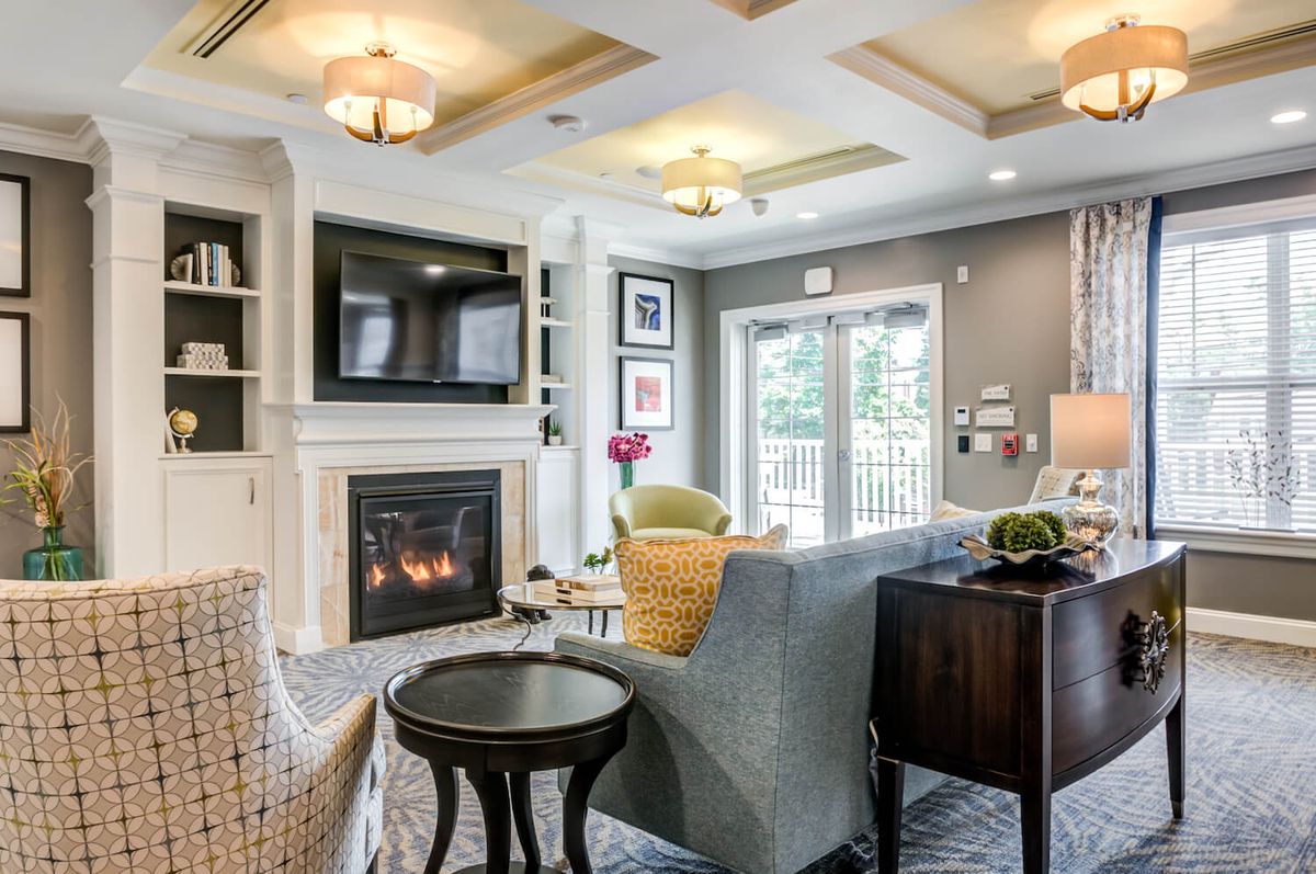 A beautifully designed living room with a cozy fireplace, elegant sofa, and modern decor.