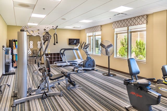 A well-equipped gym with various fitness machines and exercise equipment.