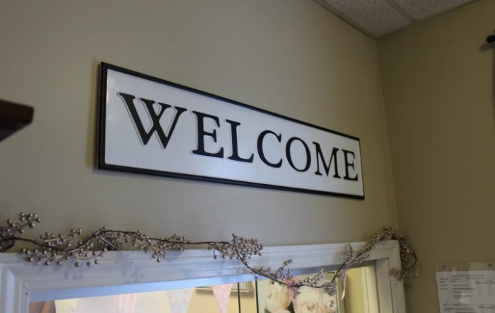 A welcoming sign displayed indoors.