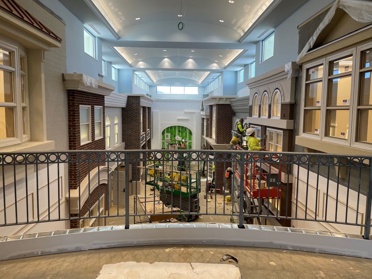 A spacious indoor atrium with architectural details and ample natural lighting.