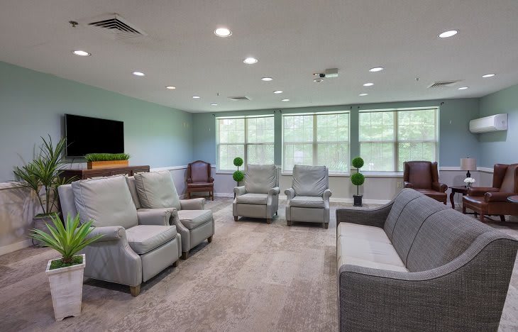 A spacious living room with comfortable seating and large windows.