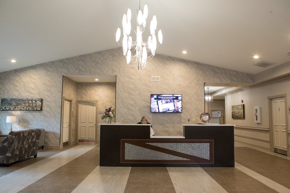 A modern reception area with a stylish chandelier and sleek design.