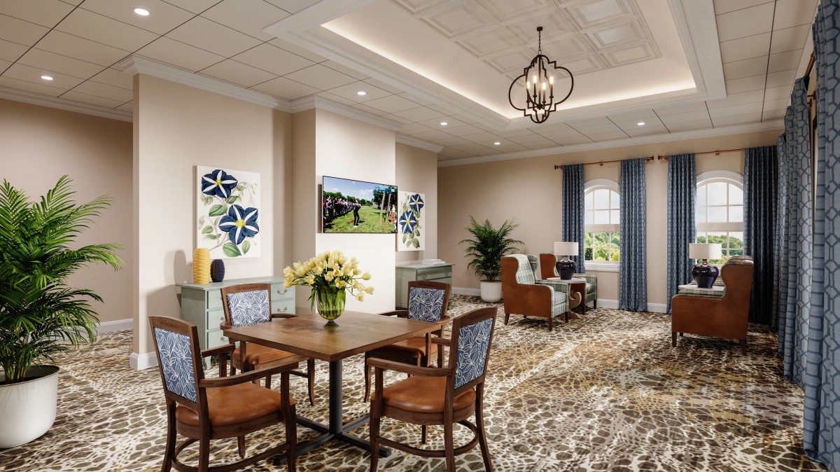 A well-decorated living room featuring a table and chairs, artwork on the walls, and a chandelier.