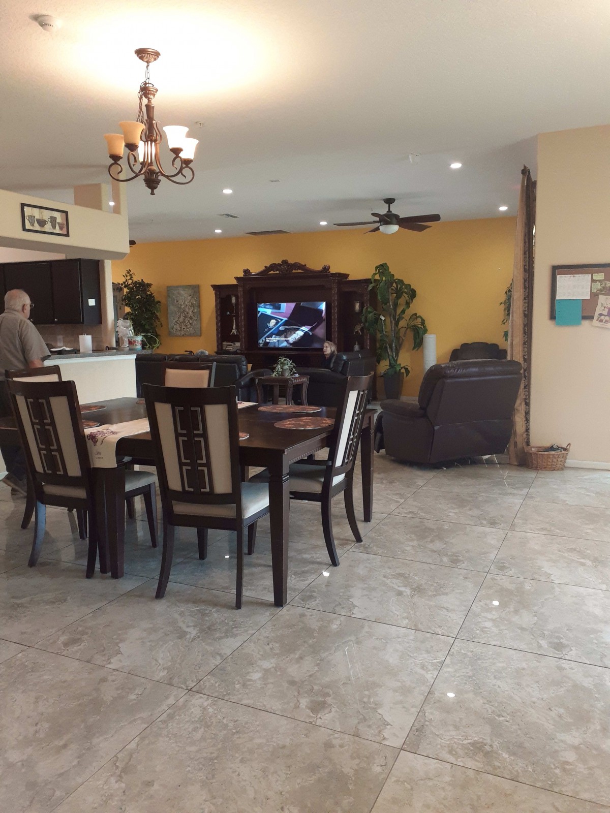 A spacious living and dining area with a dining table, television, and comfortable seating.