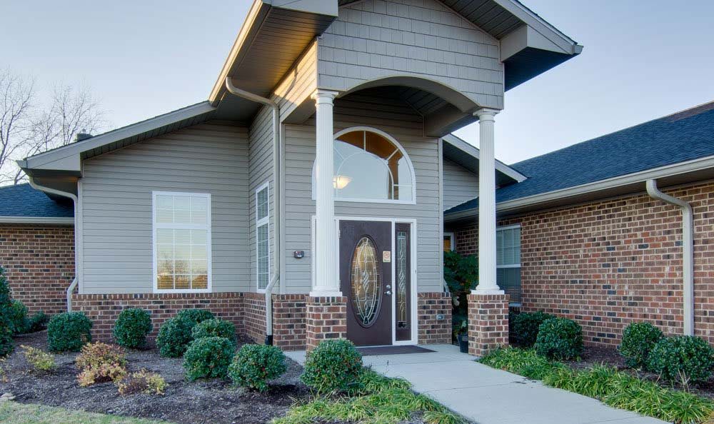 A modern house entrance with a covered porch and columns.