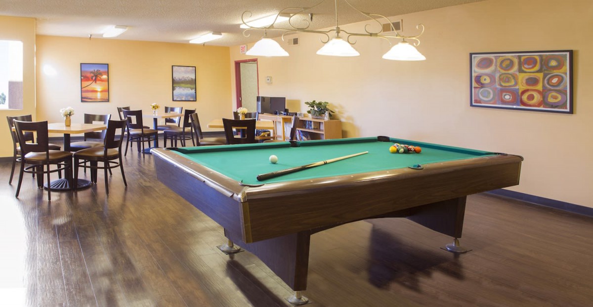 A cozy game room featuring a pool table and seating area.