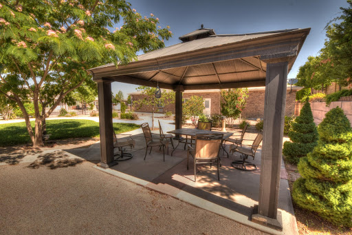 A cozy gazebo surrounded by greenery, perfect for relaxation and outdoor gatherings.