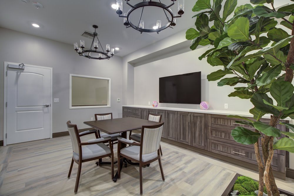 A contemporary dining area with a table, chairs, and modern decor.