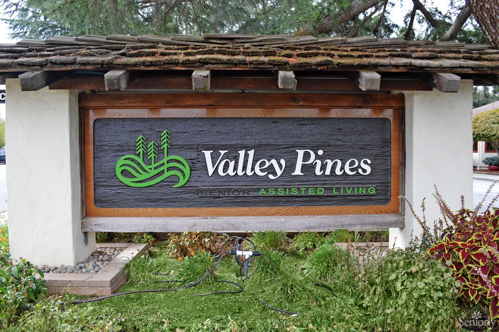 Entrance sign for Valley Pines set in a natural landscape.