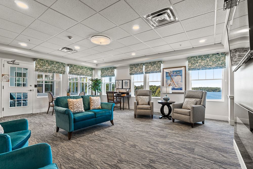 A spacious and elegantly designed living room with comfortable seating and large windows.