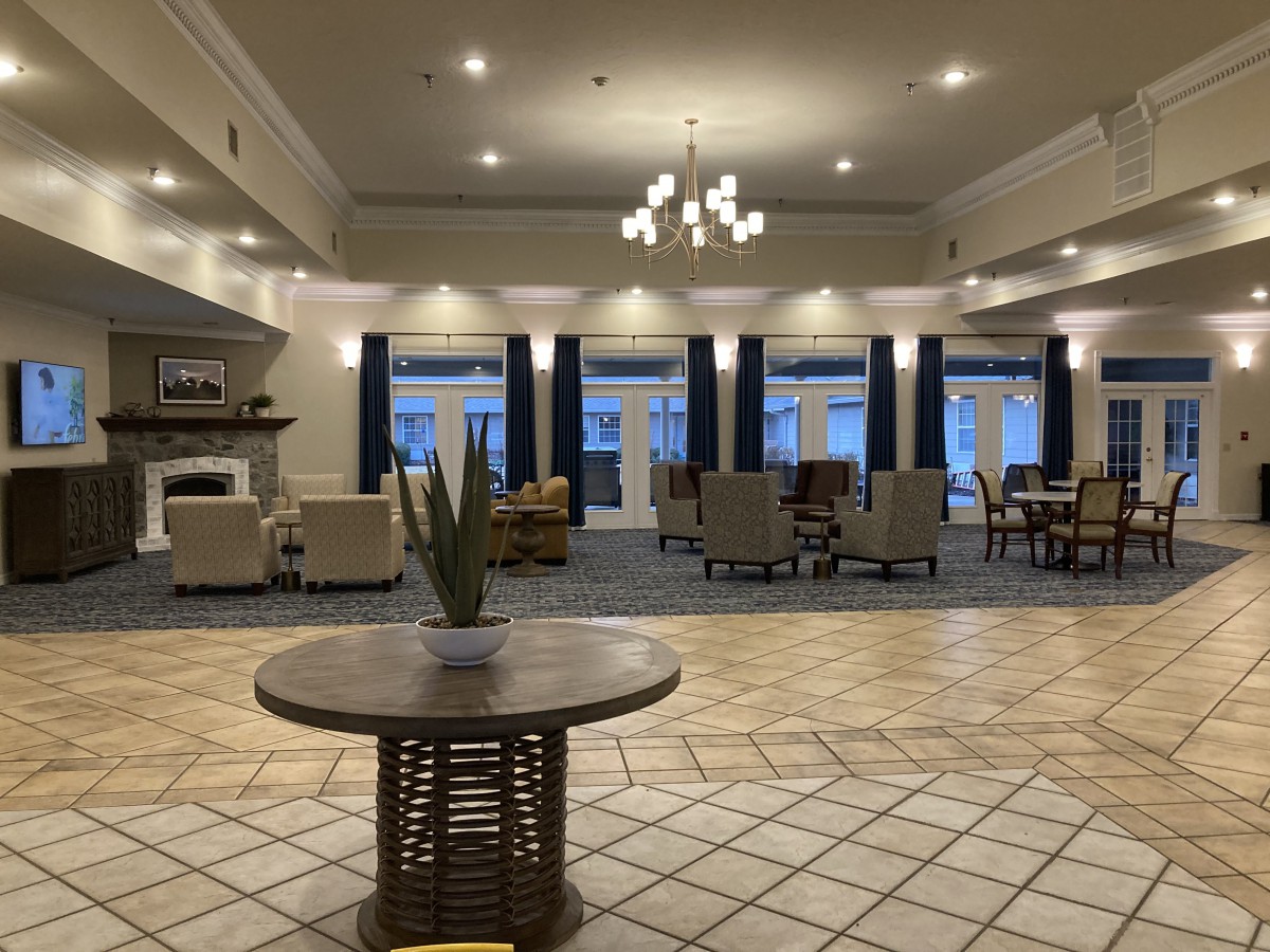 Spacious hotel lobby with seating areas and modern decor.