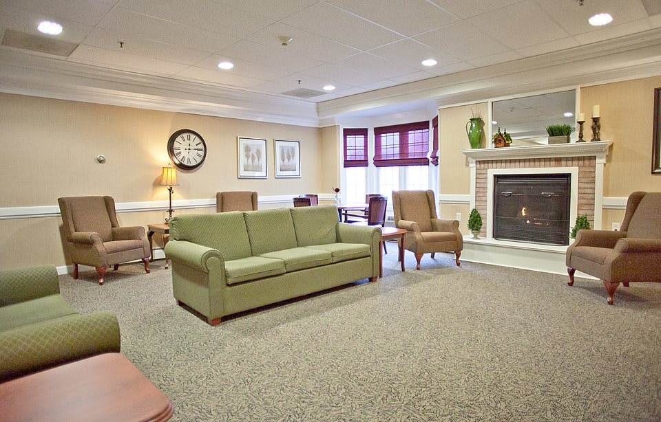 A cozy living room with comfortable seating and a fireplace.