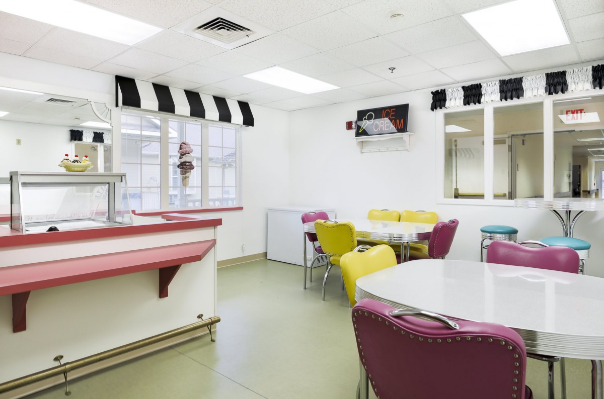 A modern cafeteria with colorful chairs and tables, featuring a clean and bright atmosphere.