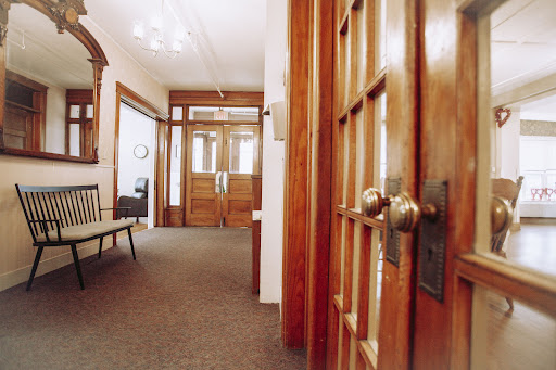 A warm and inviting corridor featuring wooden doors and stylish decor.