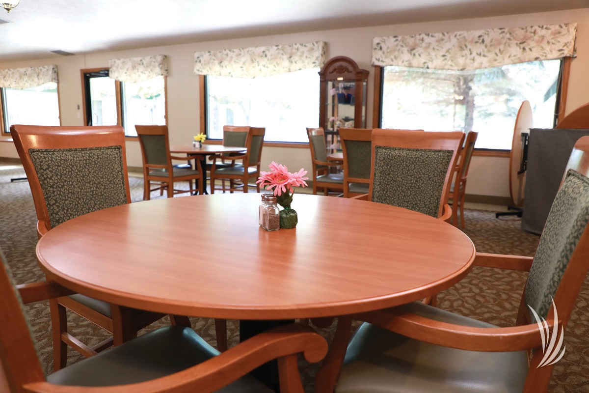A cozy dining area with wooden furniture and a round table centerpiece.